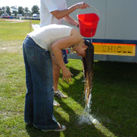 Festival Essentials List and Festival Camping Checklist - Hair being washed with bucket at Guilfest Guildford Festival