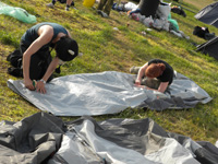 Festivals on a budget - how to save money at festivals - Ami and Mitch cleaning their tent after Glastonbury Festival