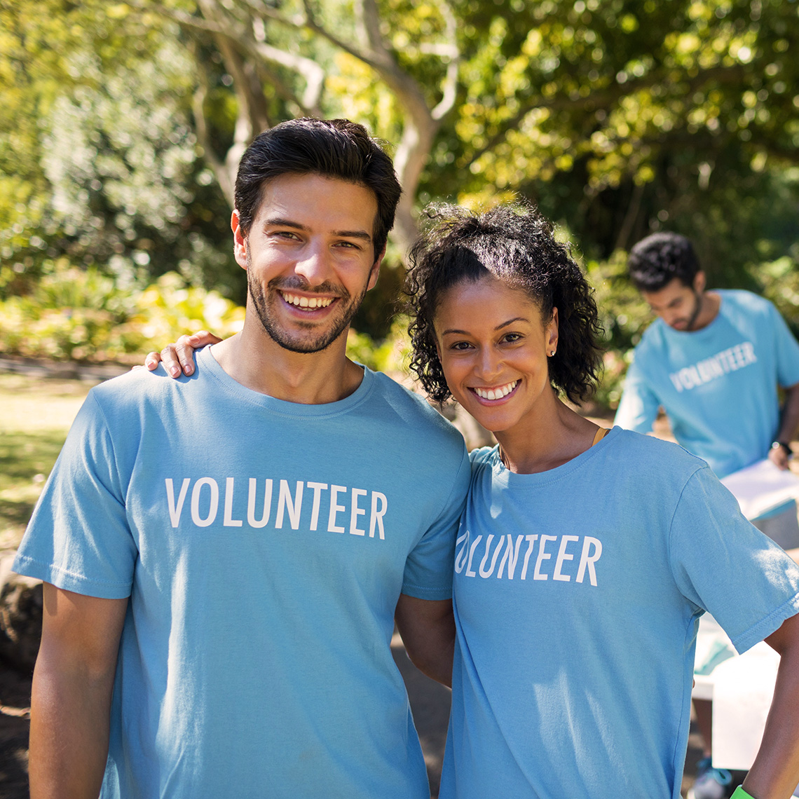 Recruit Volunteers PAAM App Smiling Volunteers with desk in Park 1140PxSq72Dpi Pg2-Img2 v22-01